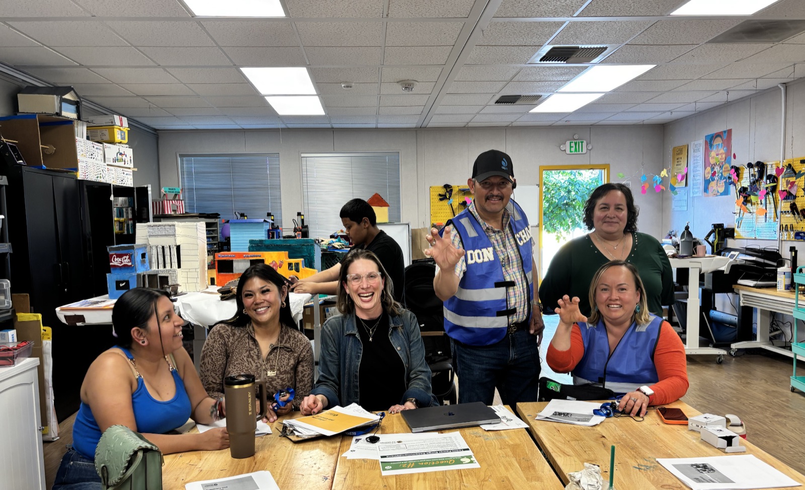 Parents and staff seated around a table during a Lit for Literacy planning meeting