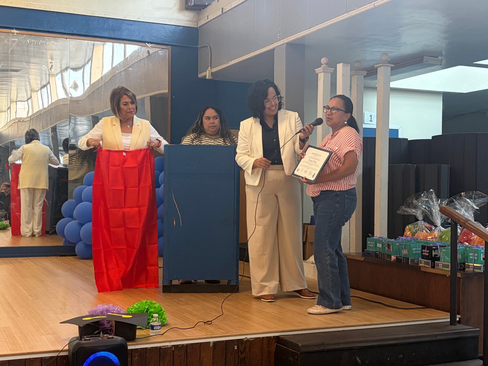 A Promise Champions parent leader receiving her certificate on stage